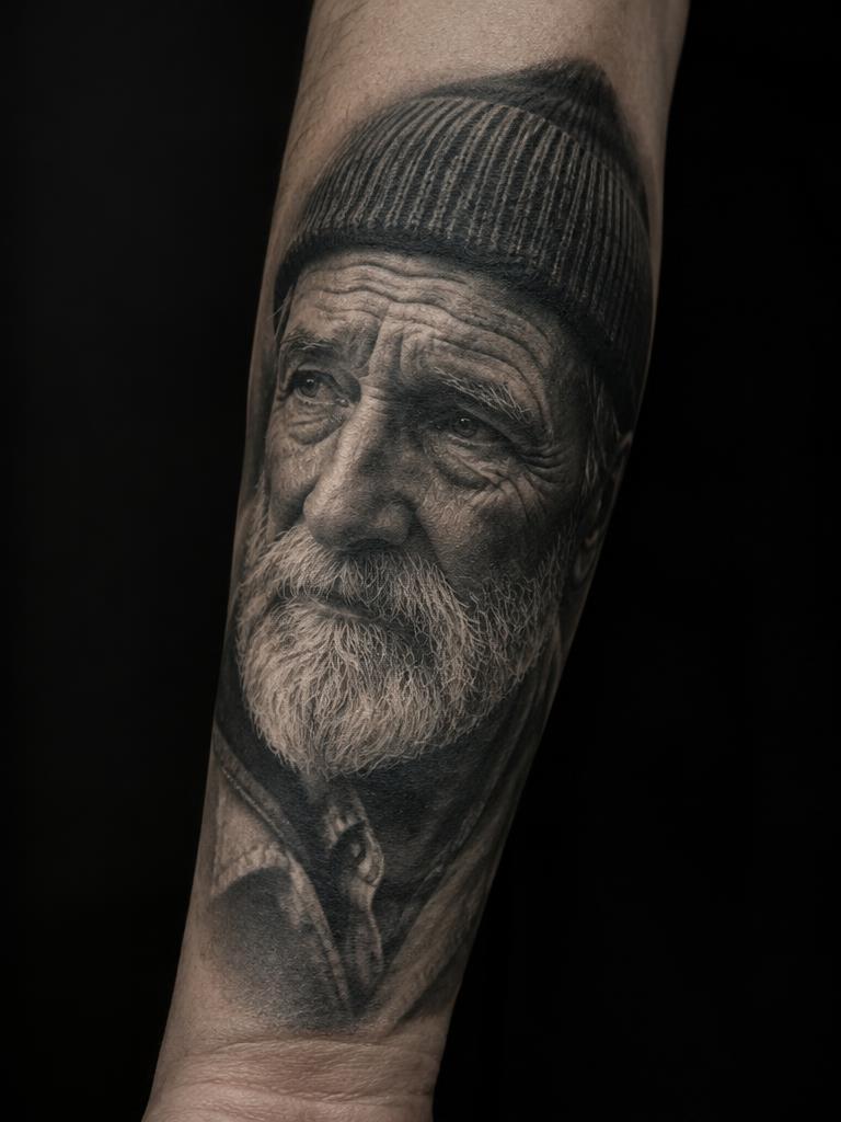 The Fisherman — realism tattoo on the forearm